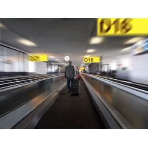 Businessman with Luggage on Travelator at Schiphol Airport, Amsterdam 