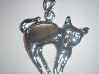 This is a pretty and fun amulet with an oval black lip shell in the 