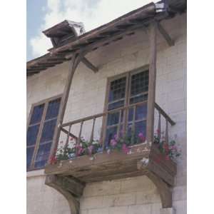  View of Exterior of Building with Flowers Growing on Wooden Balcony 
