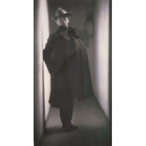  1901 Edward Steichen, in coat and hat, standing in hallway 